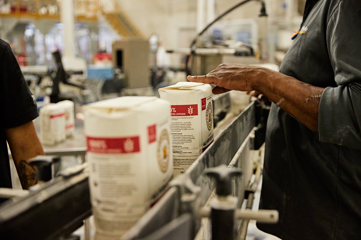 Bags of King Arthur organic flour being processed 